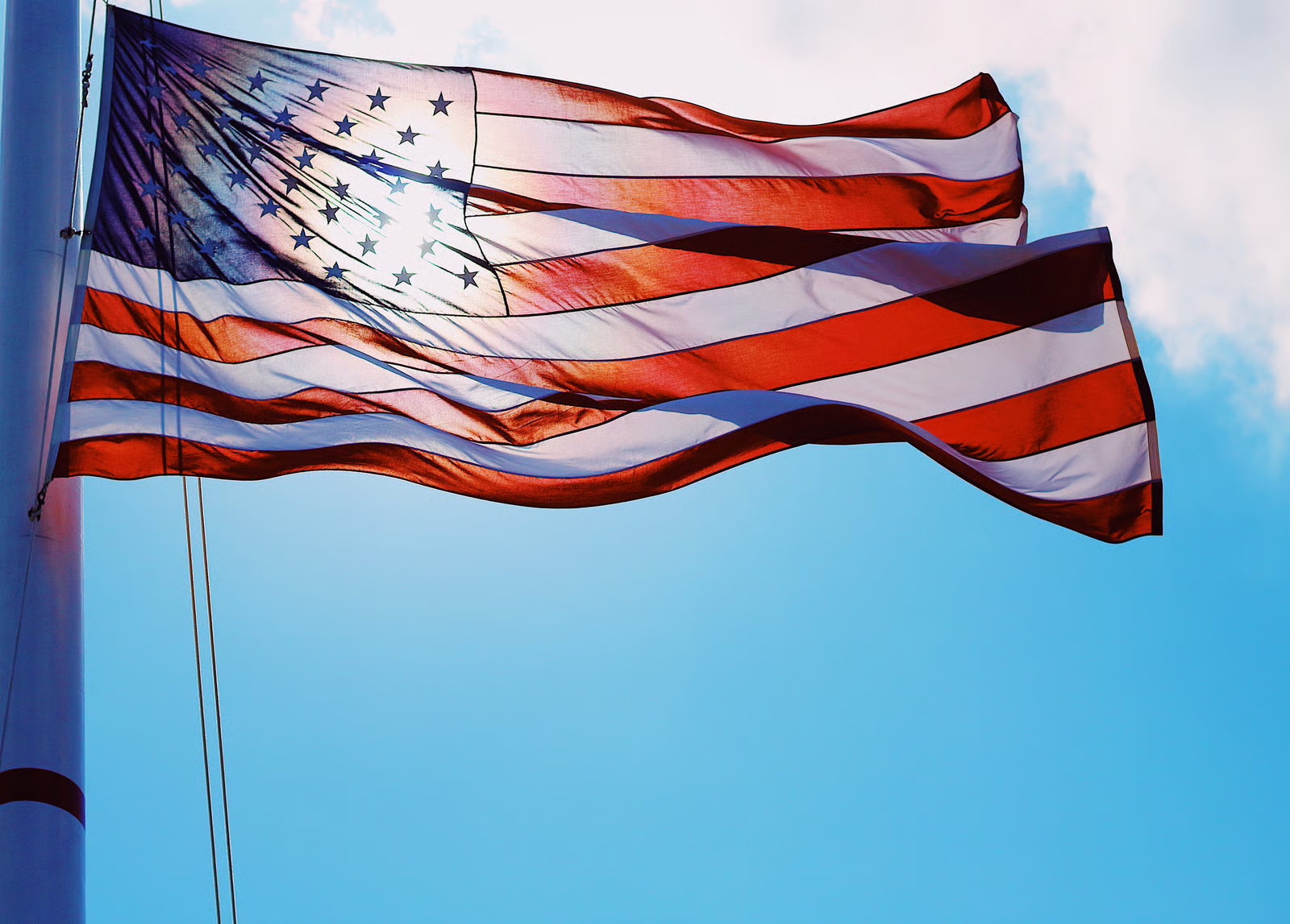 American flag honoring fire alarm technology history and firefighter sacrifice