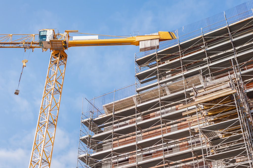 high rise building under construction scaffolding crane temporary fire alarm systems during construction